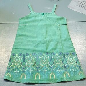 Little girls green with cross stitch dress. Size large 5 years. ADORABLE.